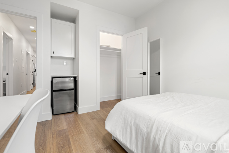 A bedroom with a large bed and a walk-in closet.