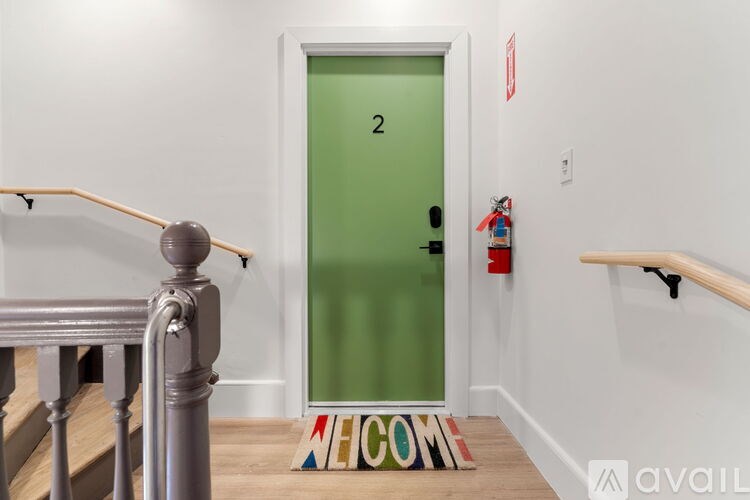 A green door with the number 2 on it.