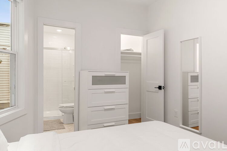 A kitchen with white cabinets and a white counter top.