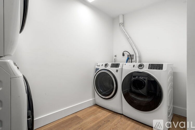 Two front loading washing machines in a laundry room.
