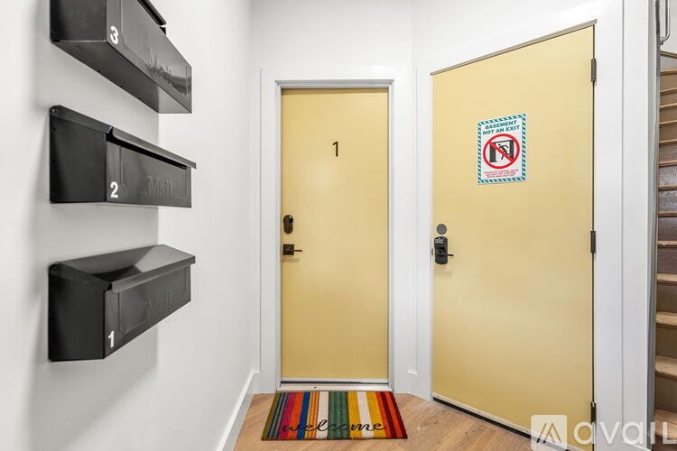 A hallway with a yellow door and a no smoking sign on the door.