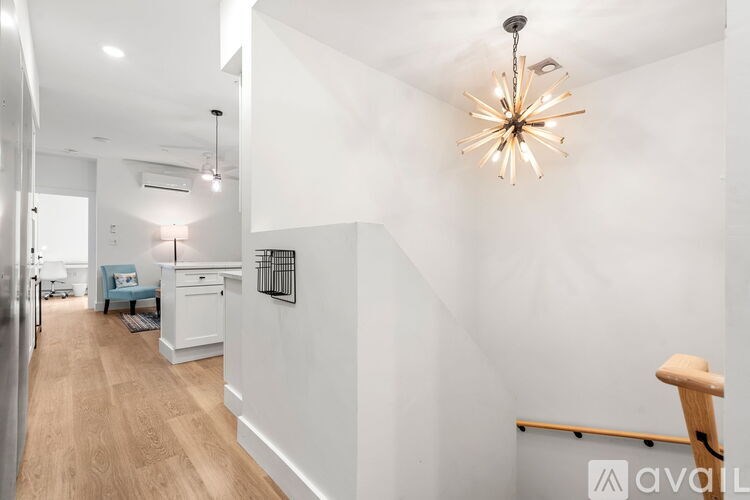 A long hallway with a light hanging from the ceiling.
