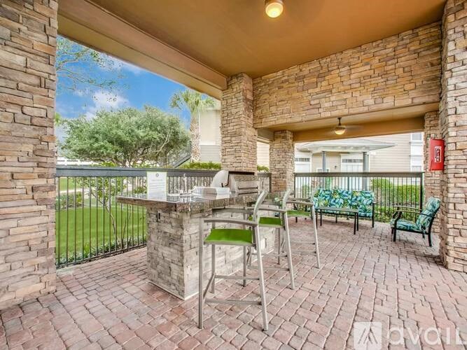 A patio with a table and chairs is covered by a roof.