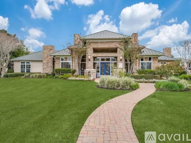 A house with a brick pathway leading to the front door.