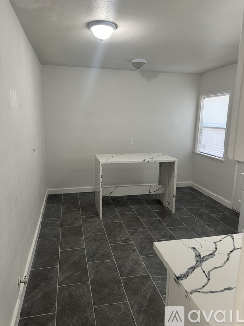A room with a table and a bench.