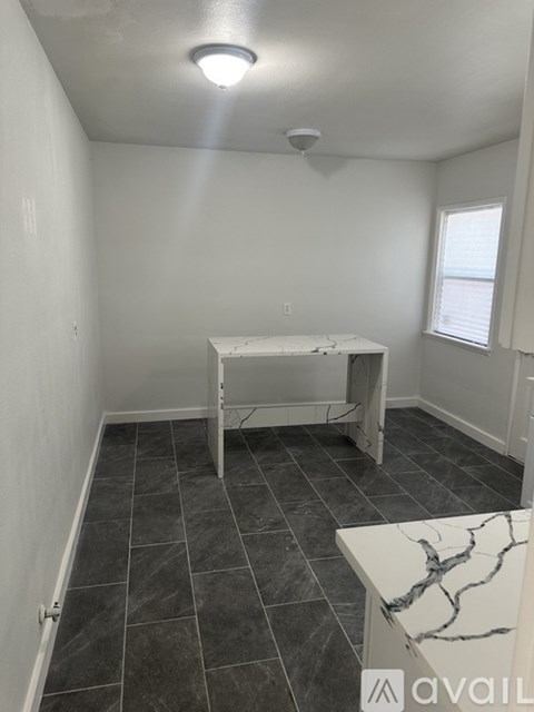 A room with a table and a bench.