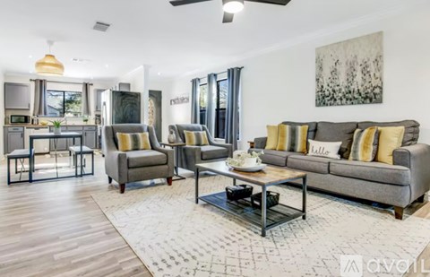 A modern living room with a grey sofa and a coffee table.