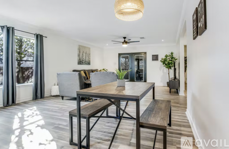 A modern dining area with a wooden table and bench.