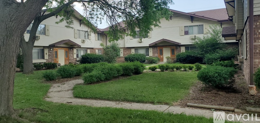 A row of houses with a lawn in front.