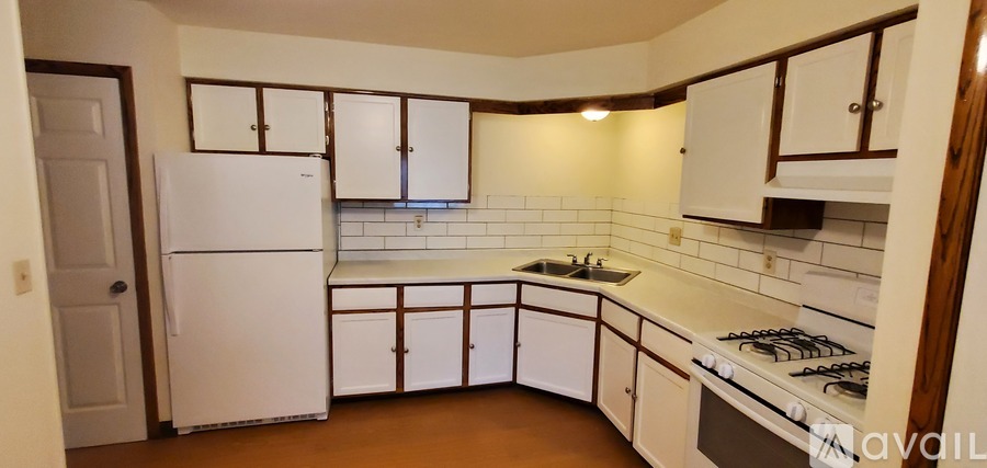 A kitchen with white appliances and white cabinets.