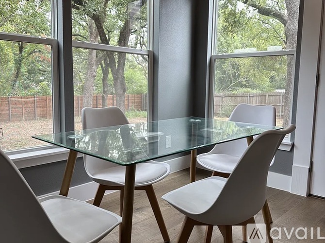 A kitchen with a stainless steel refrigerator and wooden countertops.