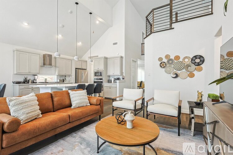 A living room with a brown couch and a coffee table.