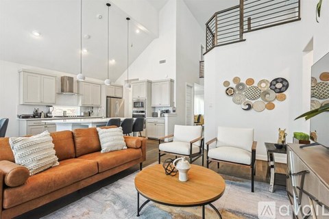 A living room with a brown couch and a coffee table.