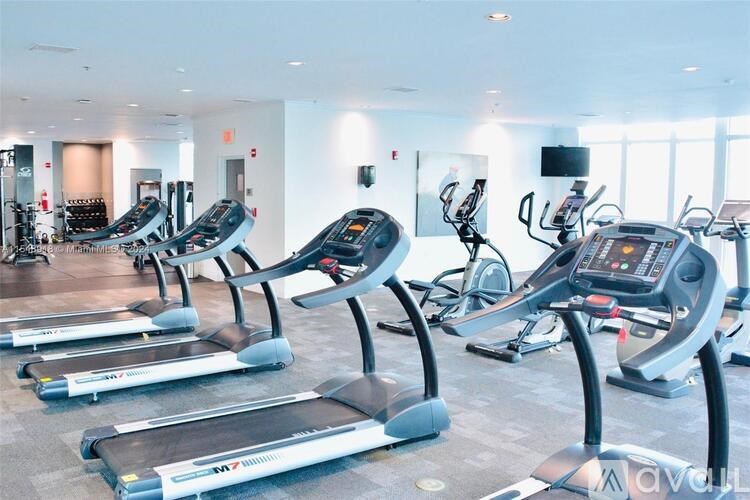A row of treadmills in a gym.