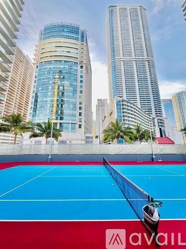 A tennis court with a net and a logo that says "avai" on it.