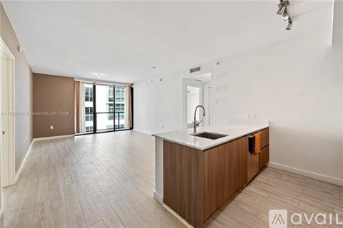A kitchen with a wooden countertop and a sink is available for rent.