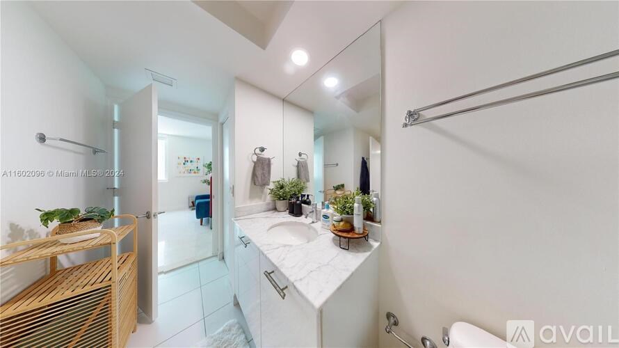 A bathroom with a white countertop and a wooden shelf.