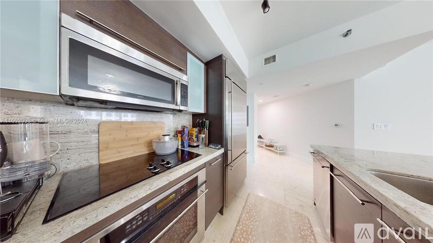 A kitchen with a stove top oven and a microwave.