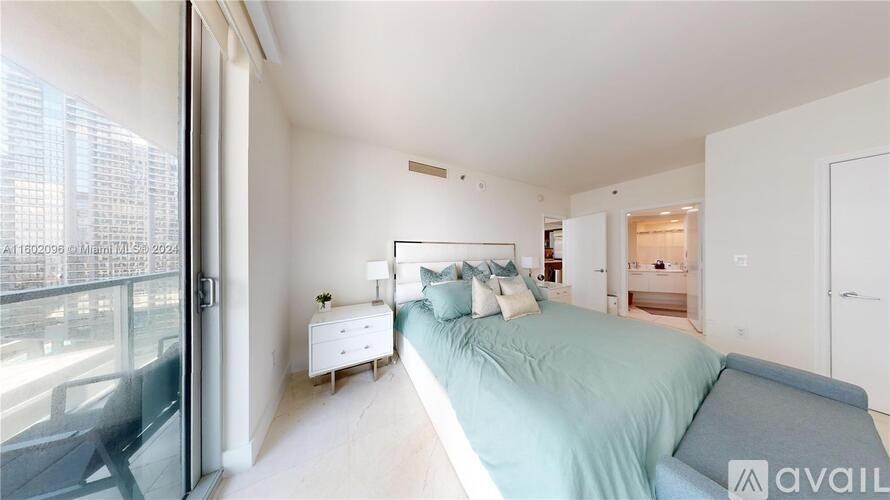 A bedroom with a bed, nightstand, and chair is available for rent.