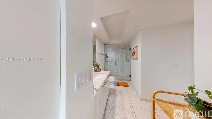 A white interior with a wooden table and a plant on it.