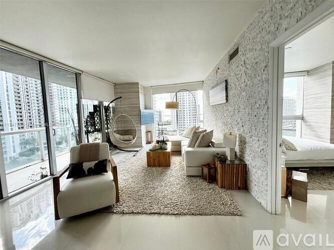 A modern living room with a large window and a view of the city.