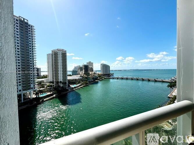 A view from a balcony overlooking a body of water with buildings in the background.