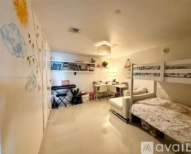 A bedroom with a bed, desk, and chair.