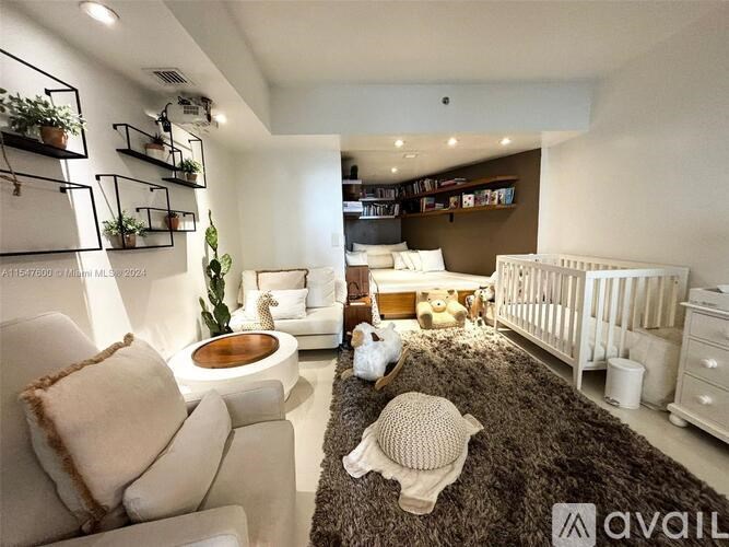 A baby nursery with a white crib, a brown rug, and a white chair with a pillow.