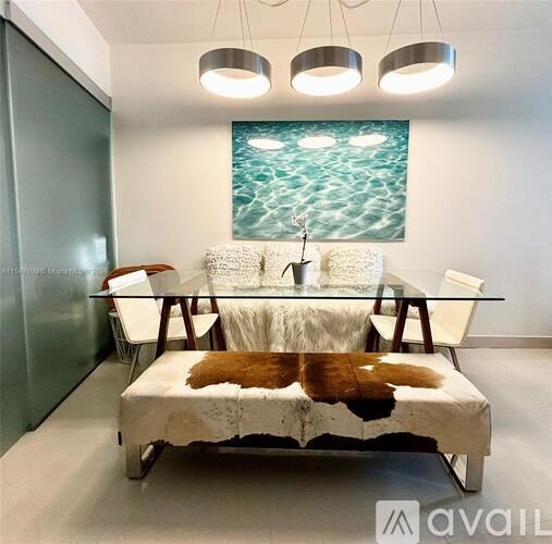 A modern living room with a white sofa and a glass table.