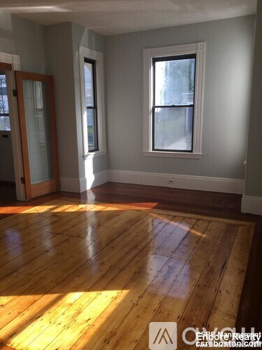 A room with wooden floors and a window.
