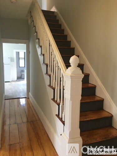 A staircase with a white balustrade and wooden steps.
