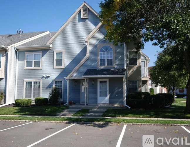 A blue house with a white door and windows.