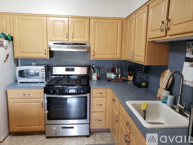 A kitchen with wooden cabinets and a black stove top oven.