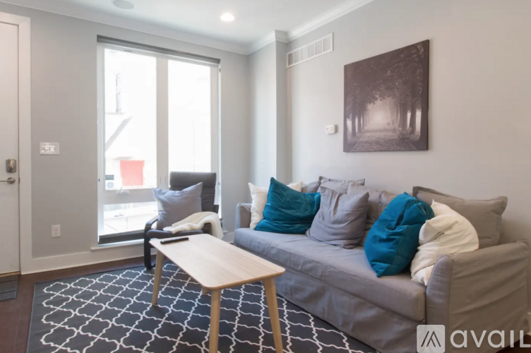 A living room with a grey couch and a wooden table.