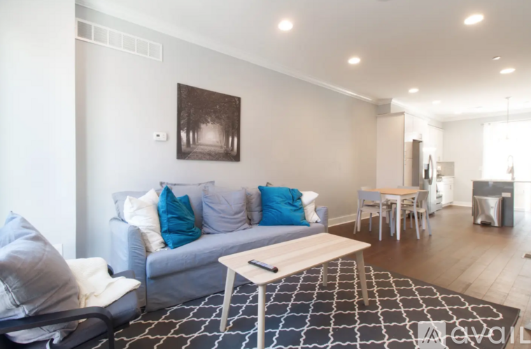 A living room with a grey couch and a coffee table.