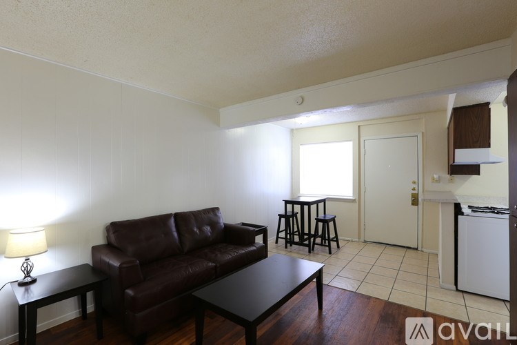 A living room with a brown leather couch and a black coffee table.