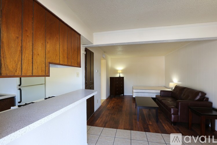A living room with a brown leather couch and a white counter.
