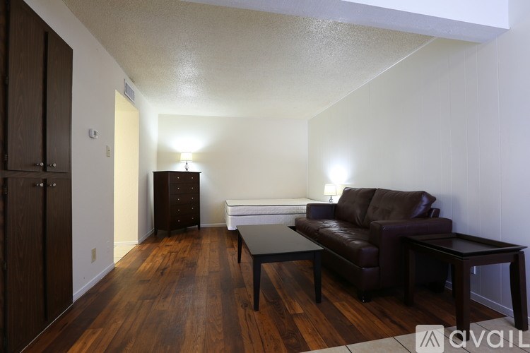A living room with a brown leather couch and a black coffee table.