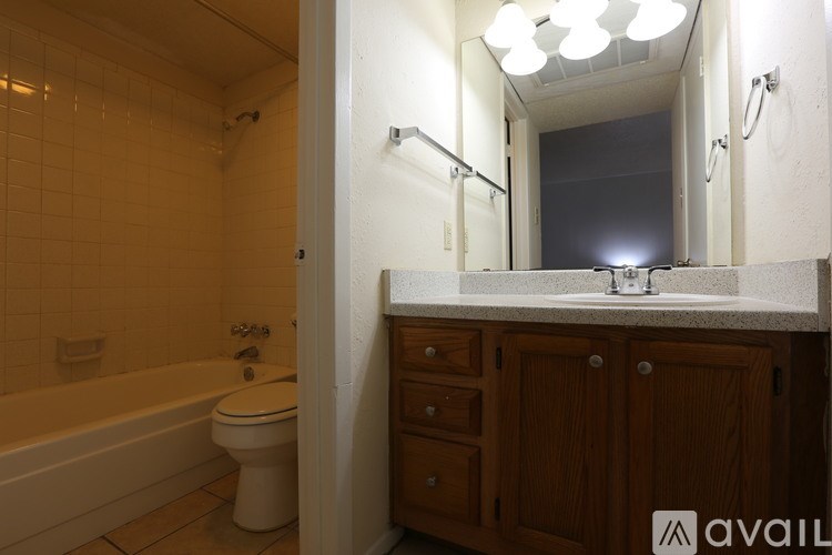 A bathroom with a white toilet and a white bathtub.