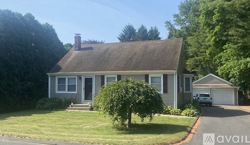 A house with a tree in front of it.
