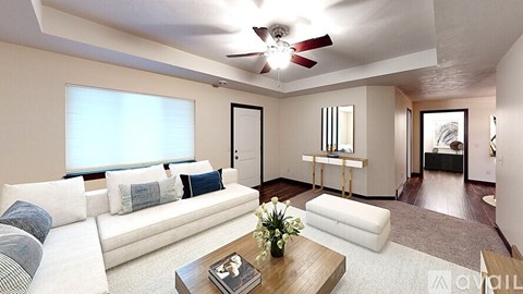 A living room with a white couch and a coffee table in the center.