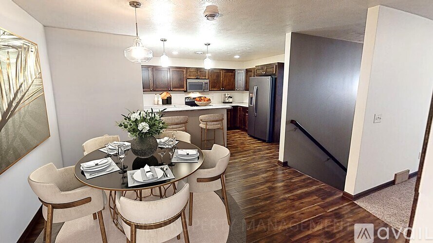 A dining room with a table set for six people.