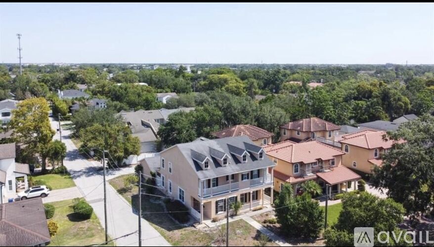 A bird's eye view of a residential area with houses and trees.