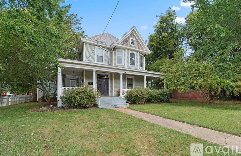 A house with a front yard and a fence.
