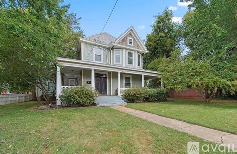 A house with a front yard and a fence.