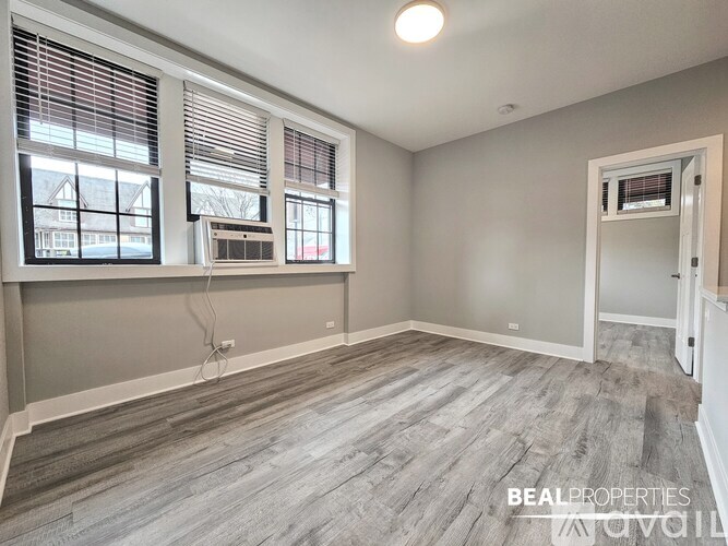 A room with a window, a door, and a wall socket.