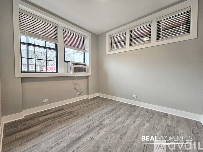 A room with a window and air conditioner unit.