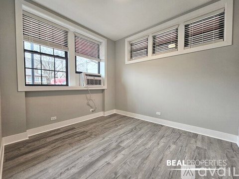 A room with a window and air conditioner unit.