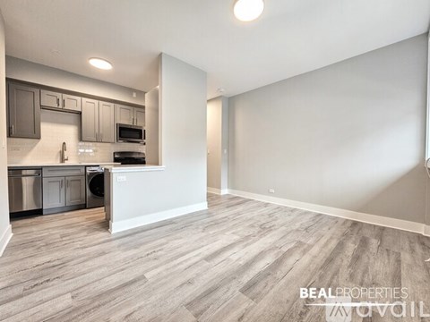 A spacious kitchen with a dishwasher and microwave.