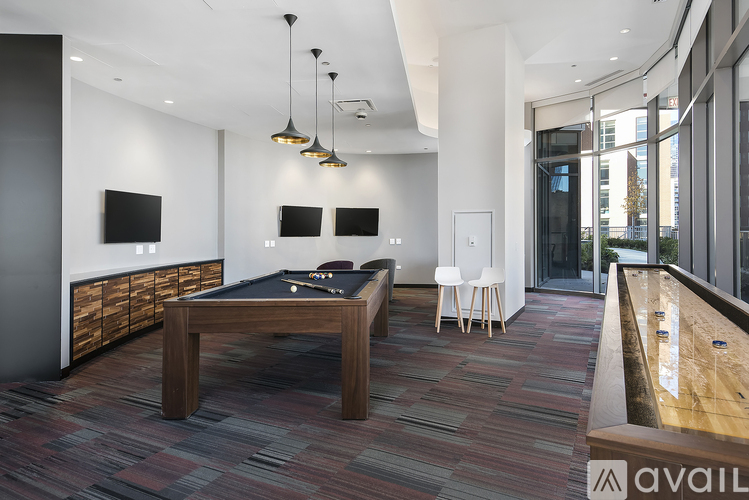 A room with a pool table and a television.